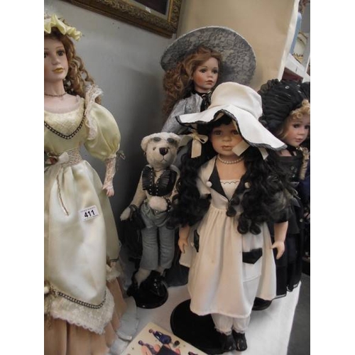 411 - A quantity of collectors dolls and 4 books