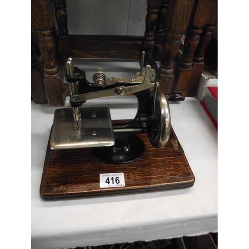 416 - A cased Lead machine sewing machine