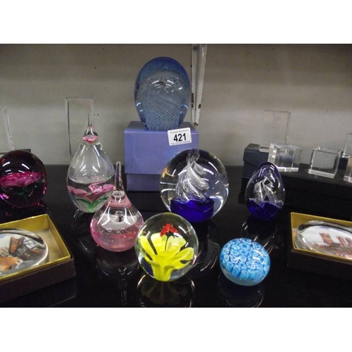 421 - A good lot of glass paperweights etc.