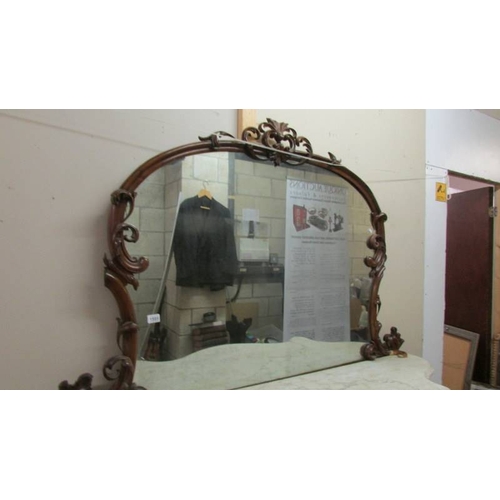 1595 - A Victorian mahogany credenza with marble top and mirror back.