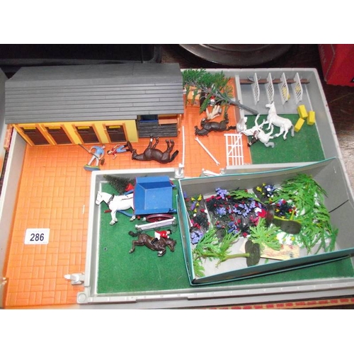 286 - A Britain's riding school and zoo diorama play sets.