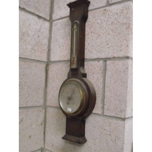 361 - An oak barometer by Barrow & Clark, Boston and one other.