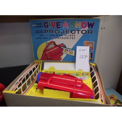 127 - A Chad valley Give-A-Show projector in box complete with slides
