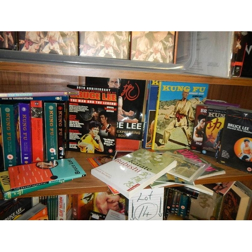 14 - Nine shelves of Bruce Lee related items, Kung Fu books. posters, videos etc.,