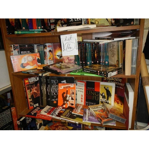 14 - Nine shelves of Bruce Lee related items, Kung Fu books. posters, videos etc.,