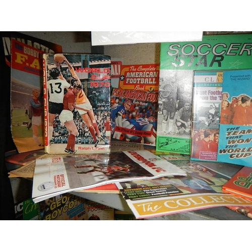 15 - A large shelf of football memorabilia - England, America etc.,