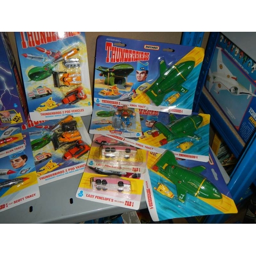 41 - A large shelf of assorted Thunderbird toys,.