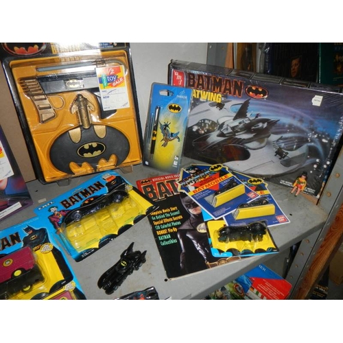 52 - A shelf of assorted Batman toys including Batjet etc.,