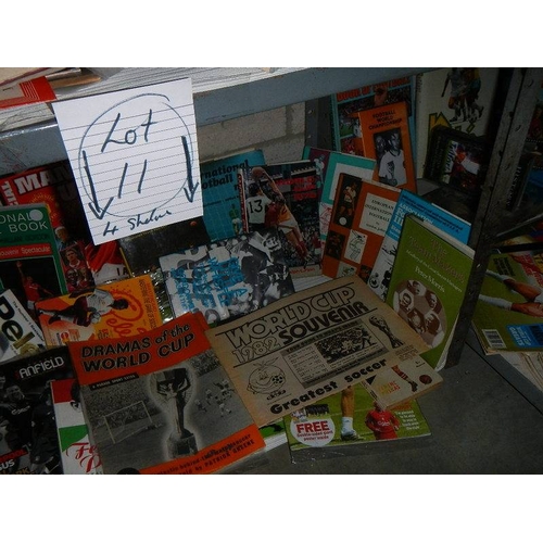 11 - 4 shelves of football related memorabilia including programmes, hard back books, paperback books, ma... 