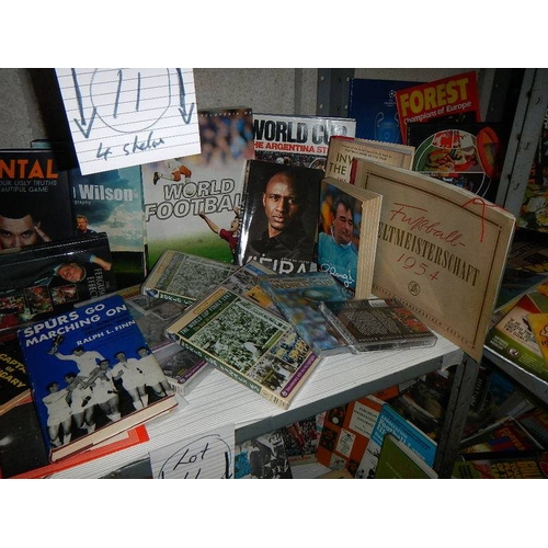11 - 4 shelves of football related memorabilia including programmes, hard back books, paperback books, ma... 
