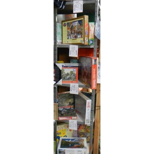 12 - 4 Shelves of jigsaw puzzles, approximately 24, all good
