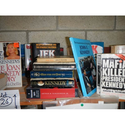 26 - Three shelves of JFK hardback books. paperback books and other memorabilia etc.,