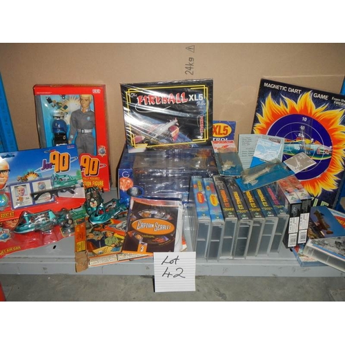 42 - A large shelf of Fireball and Joe 90 toys and videos etc.,