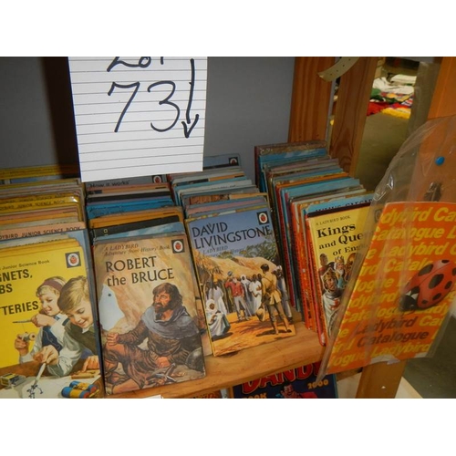 73 - A shelf of assorted Ladybird books including catalogue.