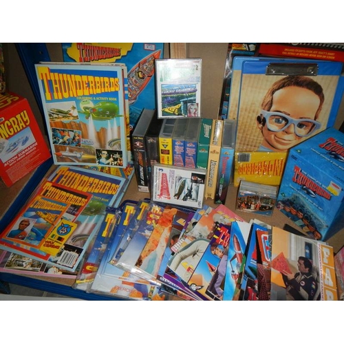 48 - A large shelf of Thunderbird books, magazines, videos, posters etc.,