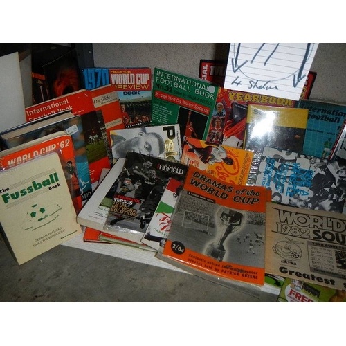 11 - 4 shelves of football related memorabilia including programmes, hard back books, paperback books, ma... 