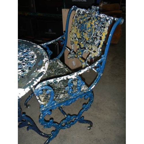 1359 - A metal circular garden table and 2 chairs,