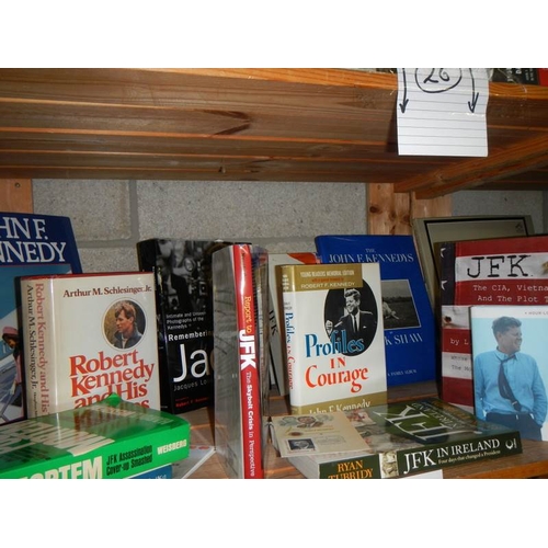 26 - Three shelves of JFK hardback books. paperback books and other memorabilia etc.,