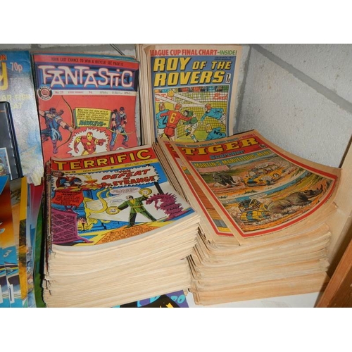 29 - A shelf of old comics including Tiger, Terrific, Batman, Sting Ray etc.,
