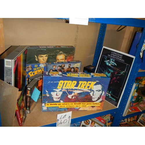 40 - A large shelf of Star Trek collectables including Jigsaw puzzles, VHS, diecast etc., (Data figure bo... 