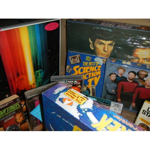 40 - A large shelf of Star Trek collectables including Jigsaw puzzles, VHS, diecast etc., (Data figure bo... 