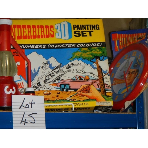 45 - A shelf of Thunderbird items including 3D painting set etc.,