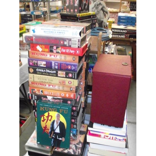 490 - A large quantity of Kung Fu collectors edition vhs videos, Bruce Lee framed prints and books on mart... 