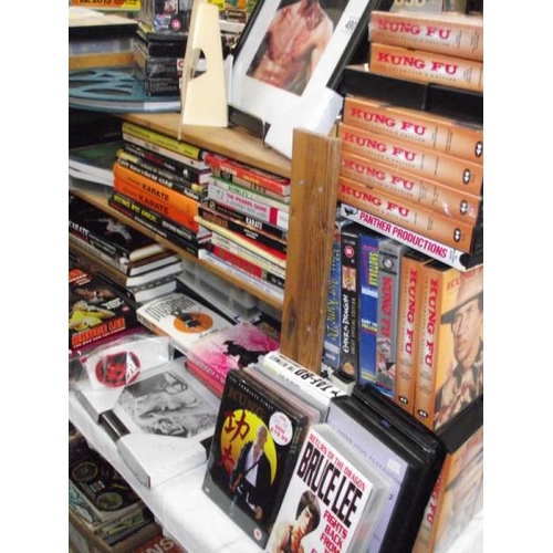 490 - A large quantity of Kung Fu collectors edition vhs videos, Bruce Lee framed prints and books on mart... 