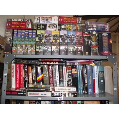 492 - A large quantity of books on war and videos, (6 shelves)