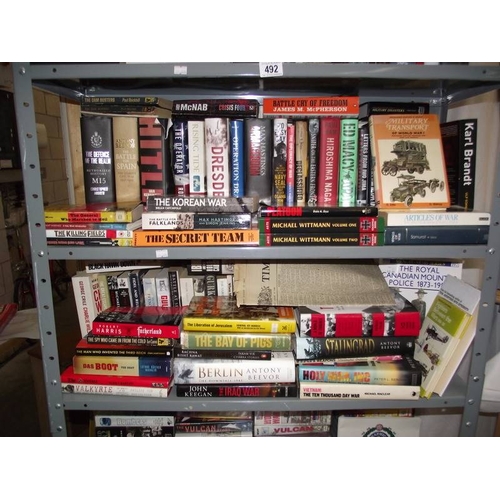 492 - A large quantity of books on war and videos, (6 shelves)