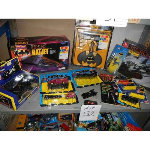 52 - A shelf of assorted Batman toys including Batjet etc.,