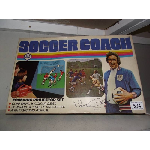 534 - A Chad valley soccer coach coaching projector