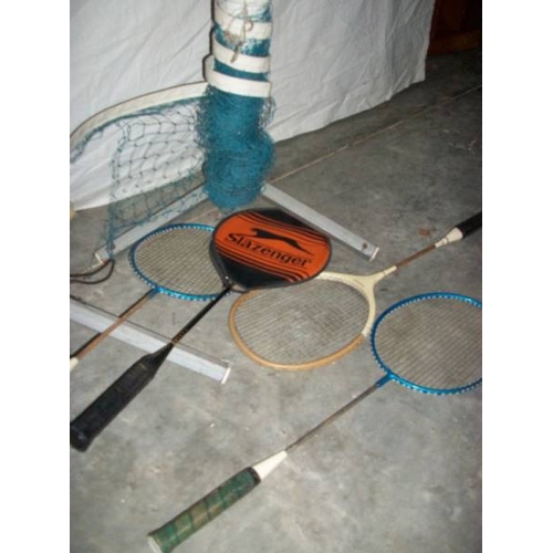 506 - A good quality badminton posts with net and four raquets.