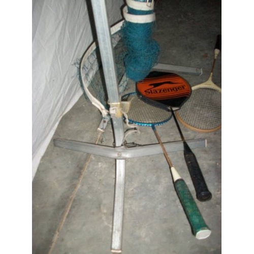 506 - A good quality badminton posts with net and four raquets.