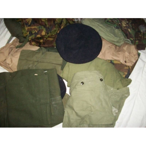 518 - A good large lot of camouflage / khaki jackets, trousers, caps, bags etc., 18 items in total.