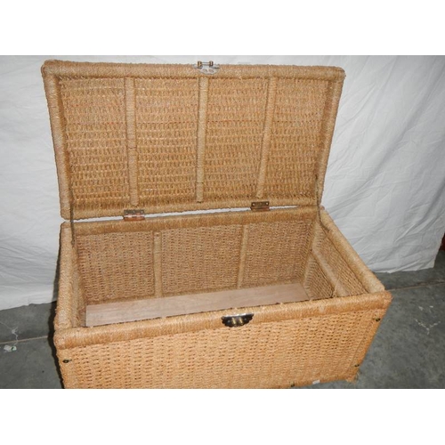 550 - A circular wicker table 63 cm diameter x 40 cm high and a rattan blanket box with hinged lid L 85 cm... 