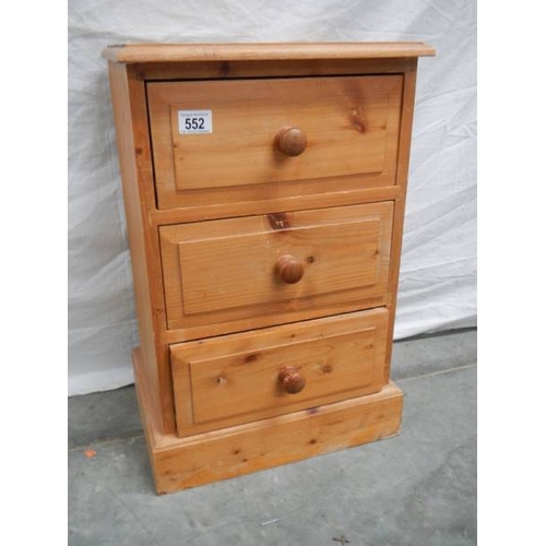 552 - A 3 drawer pine bedside chest (59 x 38 x 29 cm).