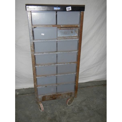 554 - A 14 drawer metal chest on wheels, 105 x 48 x 46 cm.