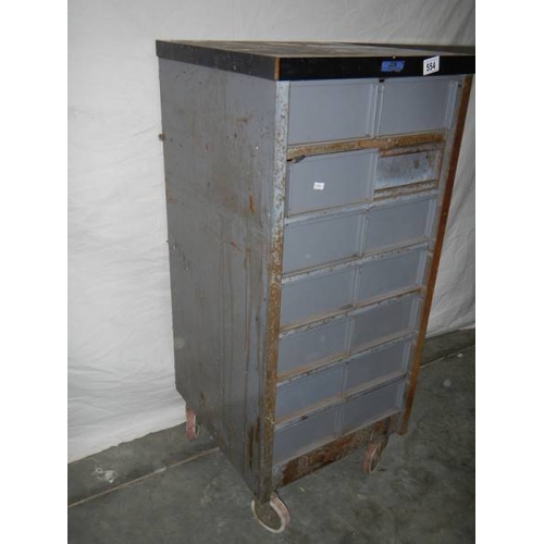 554 - A 14 drawer metal chest on wheels, 105 x 48 x 46 cm.