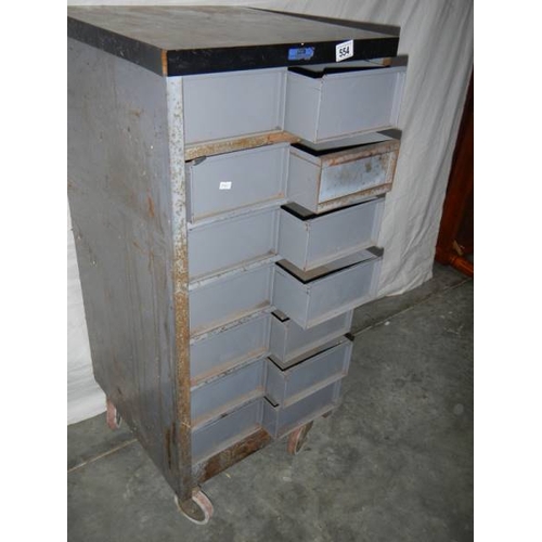 554 - A 14 drawer metal chest on wheels, 105 x 48 x 46 cm.