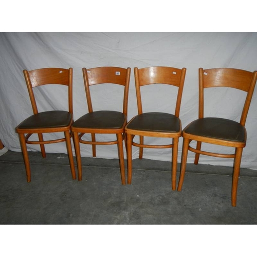 557 - 4 fine ash bentwood chairs with green vinyl seats.