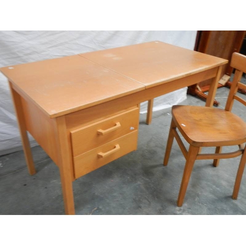 562 - An unusual office desk with 2 drawers, lift up writing slope and chair, 115 x 60 x 72 cm.