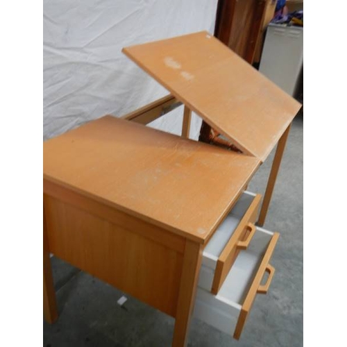 562 - An unusual office desk with 2 drawers, lift up writing slope and chair, 115 x 60 x 72 cm.