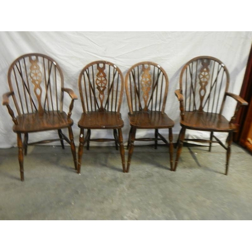 573 - A set of 4 oak wheel back chairs,.