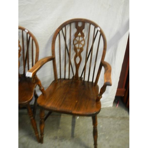 573 - A set of 4 oak wheel back chairs,.