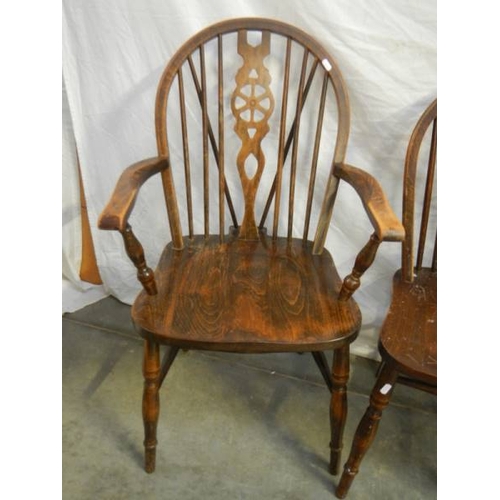 573 - A set of 4 oak wheel back chairs,.