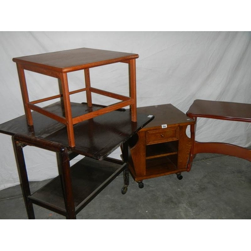 594 - An extending tea trolley, a magazine rack on wheels, a square topped side table and an oblong pine t... 