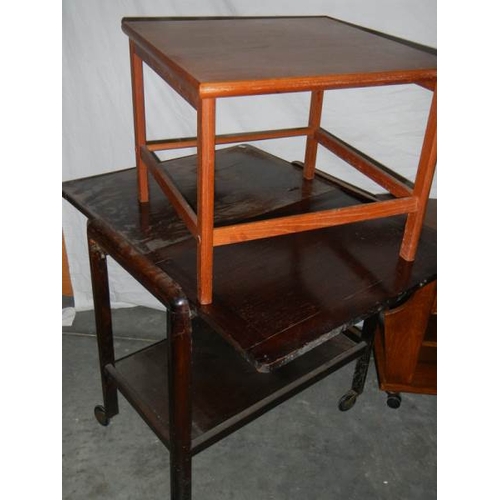 594 - An extending tea trolley, a magazine rack on wheels, a square topped side table and an oblong pine t... 