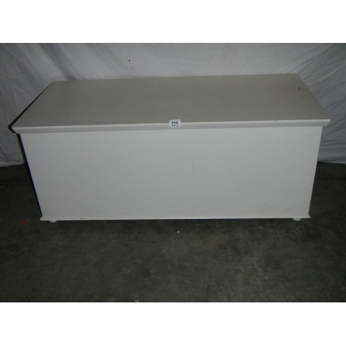 595 - A large painted blanket box on wheels.  108 x 50 x 48 cm.