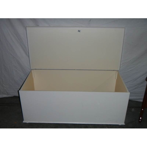 595 - A large painted blanket box on wheels.  108 x 50 x 48 cm.